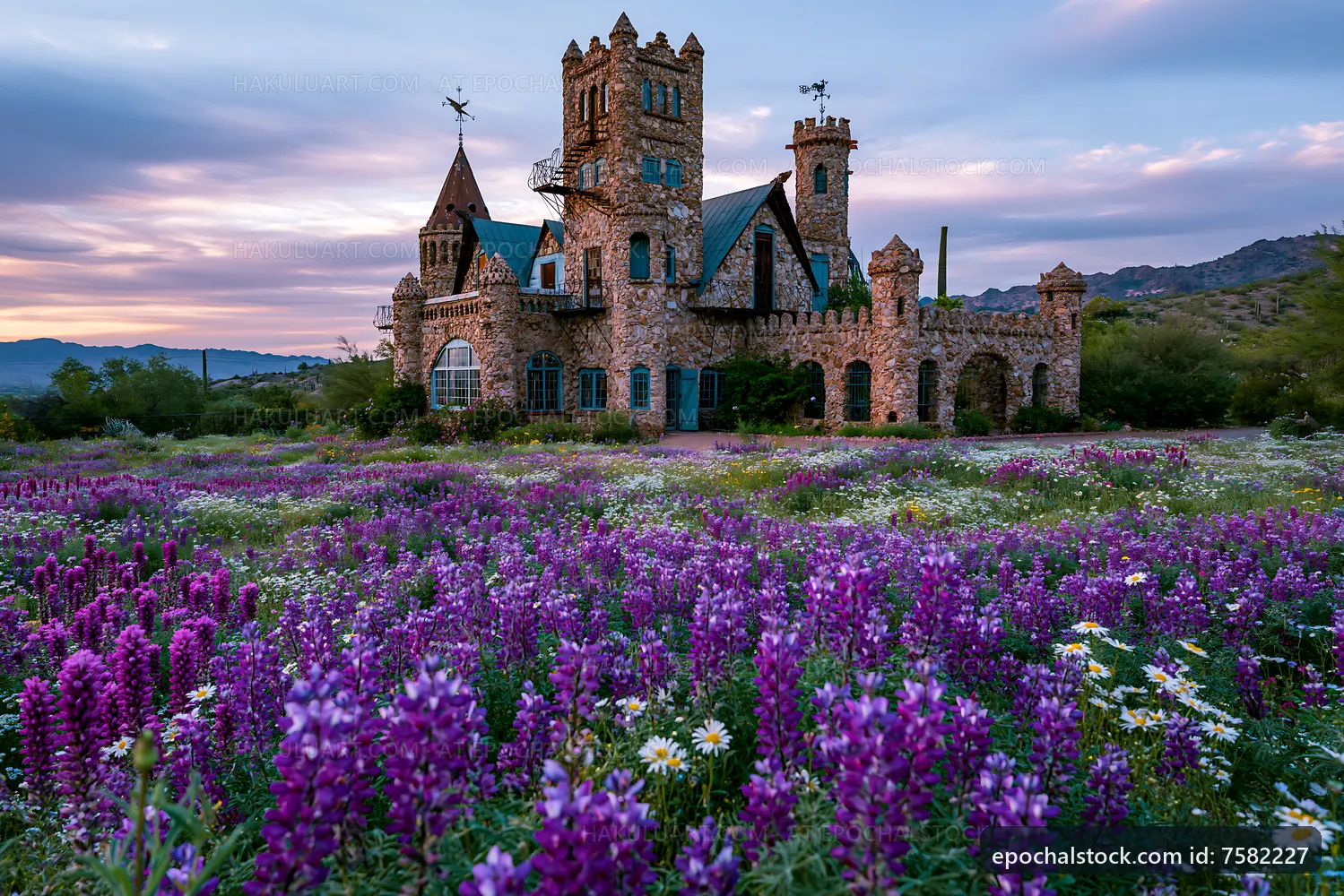 Stone castle surrounded by wildflowers at sunset