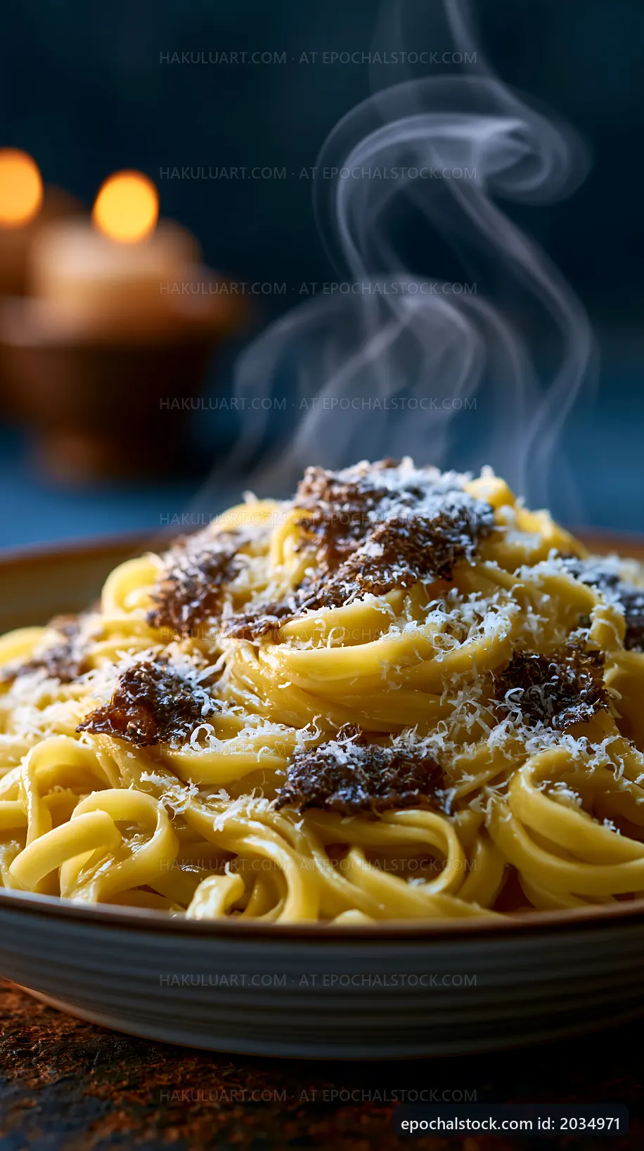 Steaming plate of pasta with sauce and cheese on a table