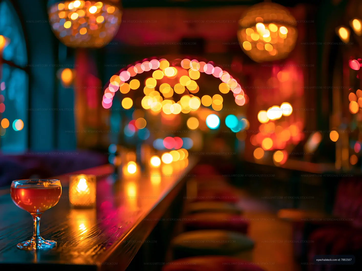 Dimly lit bar with cocktail and warm lights in the background