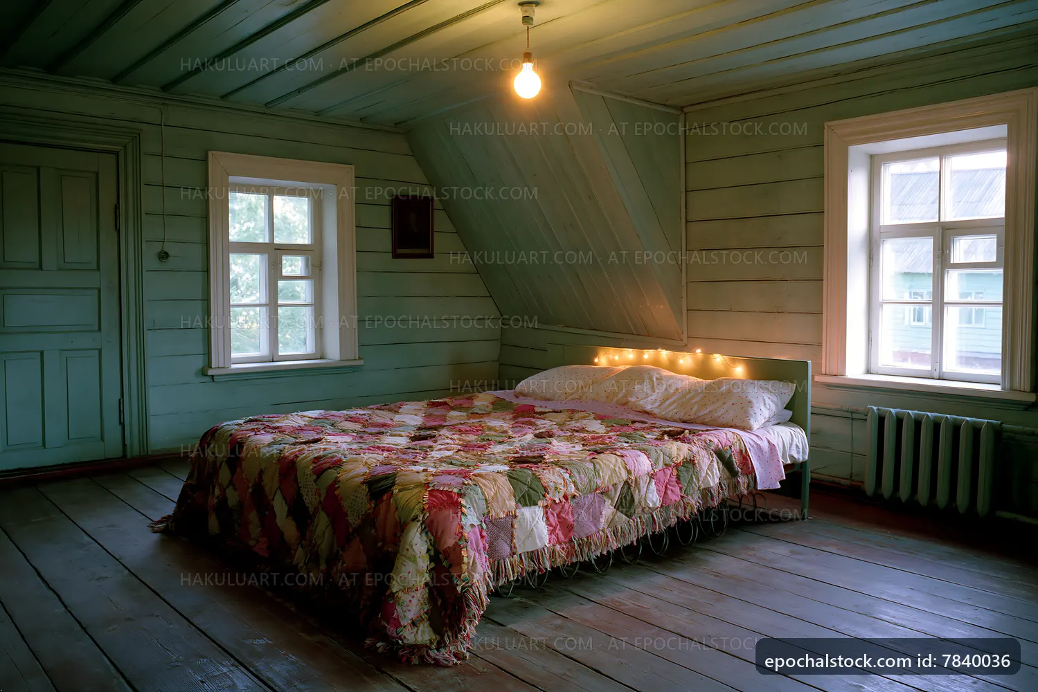 Cozy bedroom with wooden walls and quilted bedspread