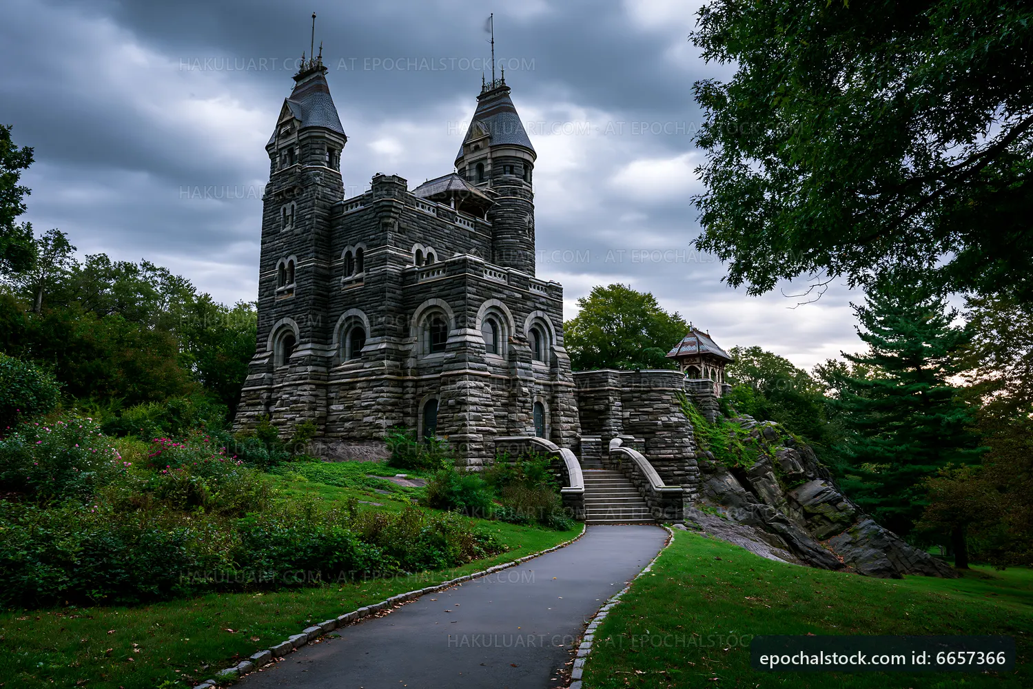 Historic stone castle surrounded by trees on a cloudy day