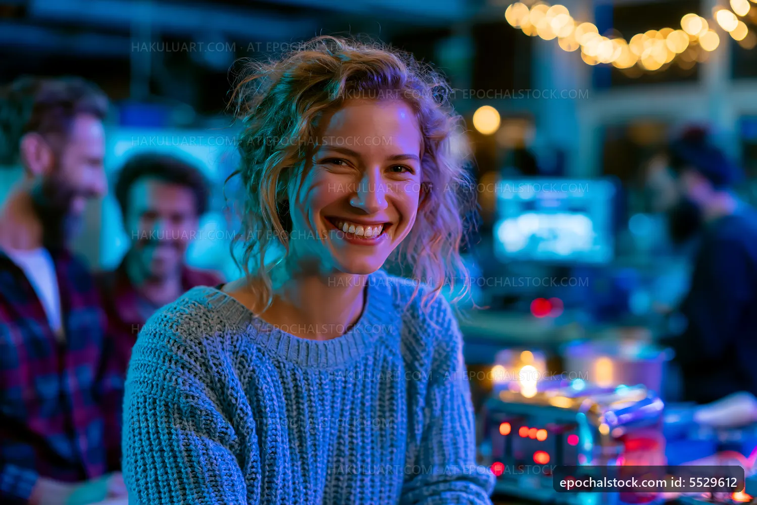 Young woman smiles in dimly lit bar with friends