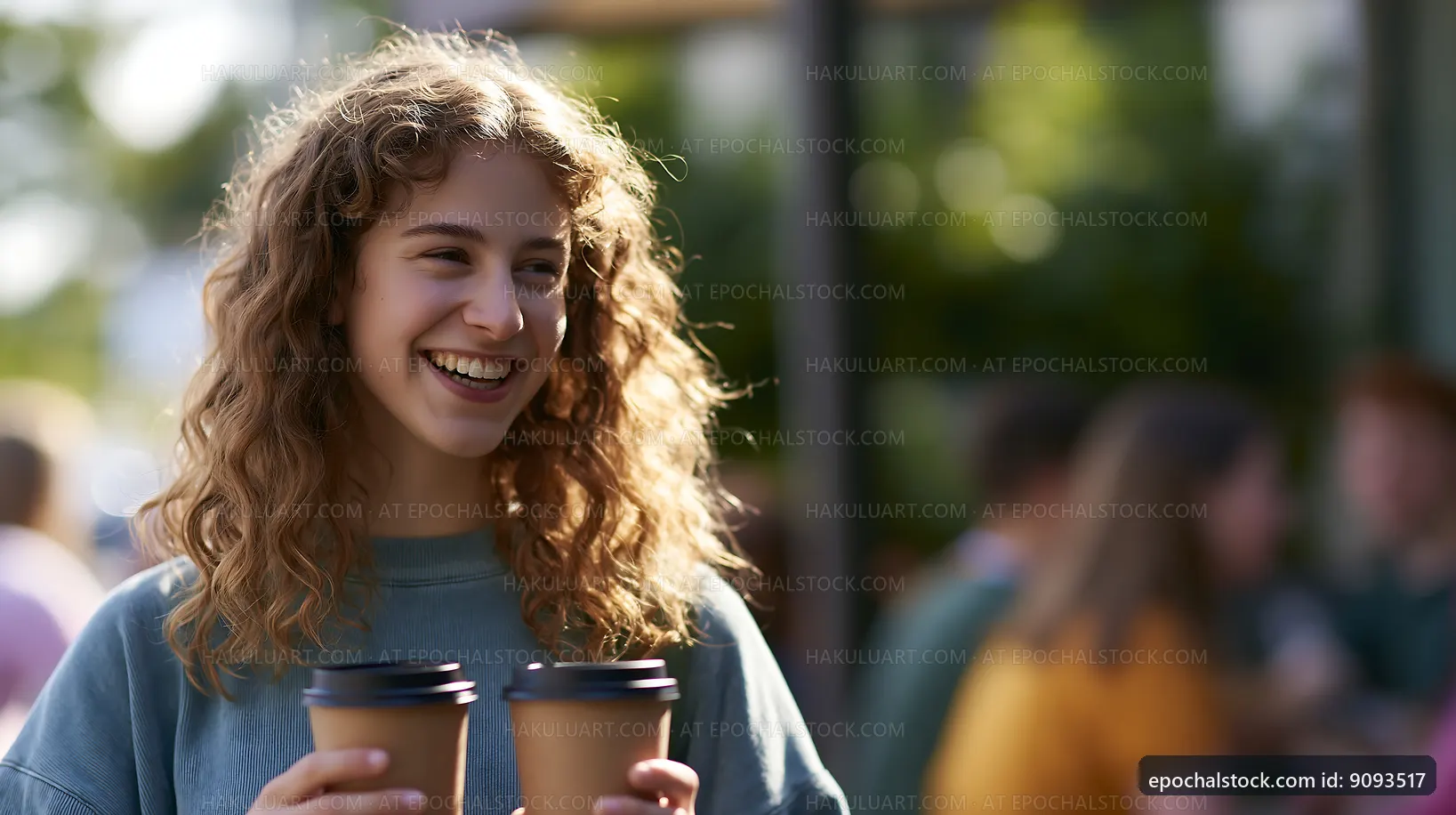 Woman smiling while holding two coffee cups outdoors