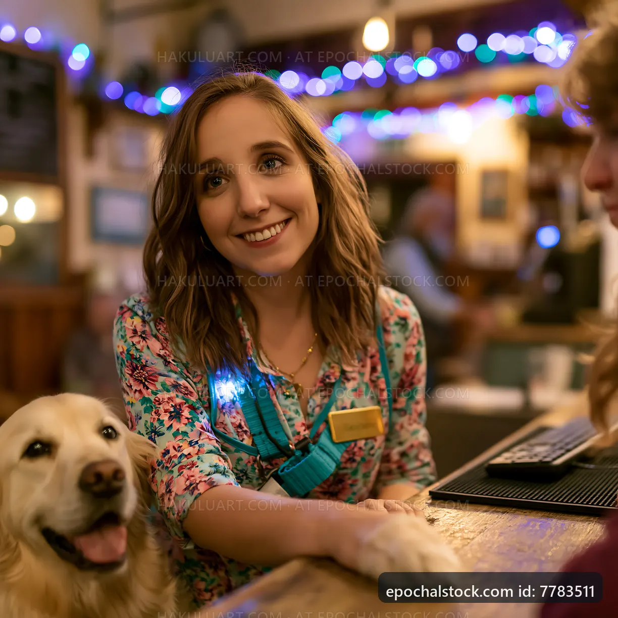 Friendly staff member at a pub with a dog during an evening