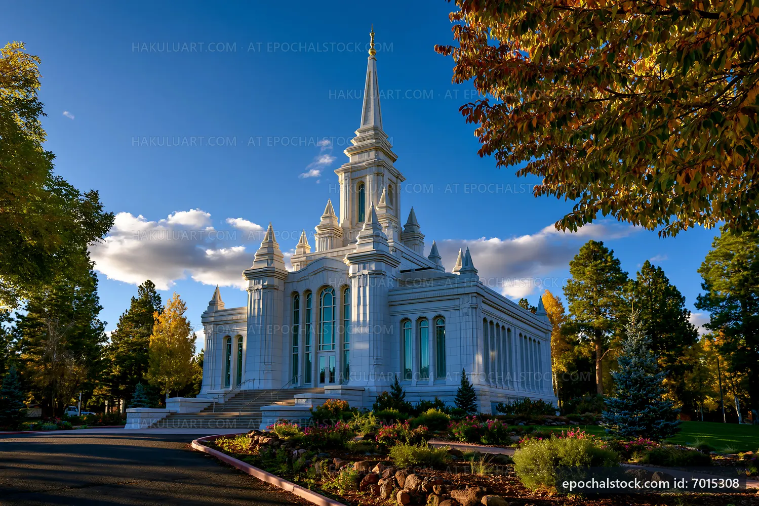 Elegant church building surrounded by trees in bright sunlight