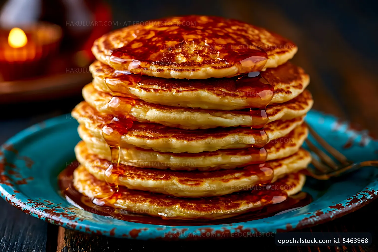 Stack of pancakes with syrup on a blue plate