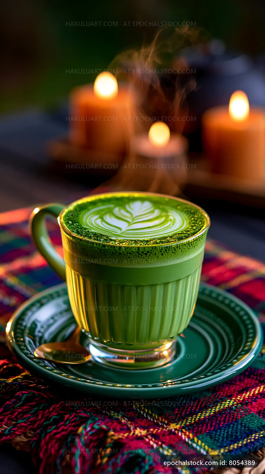 Cup of green tea with latte art and candles in the background