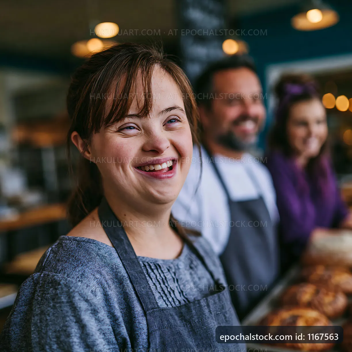 Bakers smiling at a bakery with fresh bread and pastries