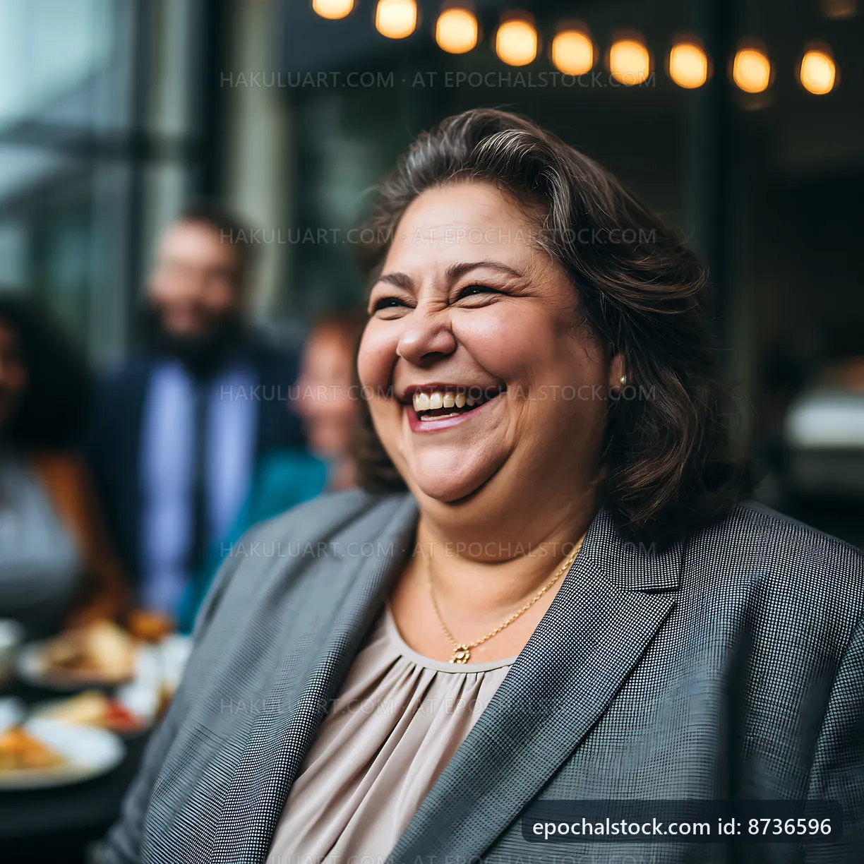 Smiling woman in a business suit at a social gathering