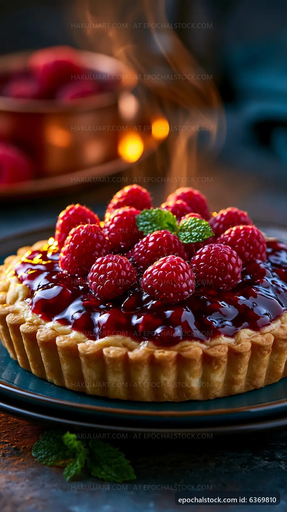 Raspberry tart sits on a plate with steam rising