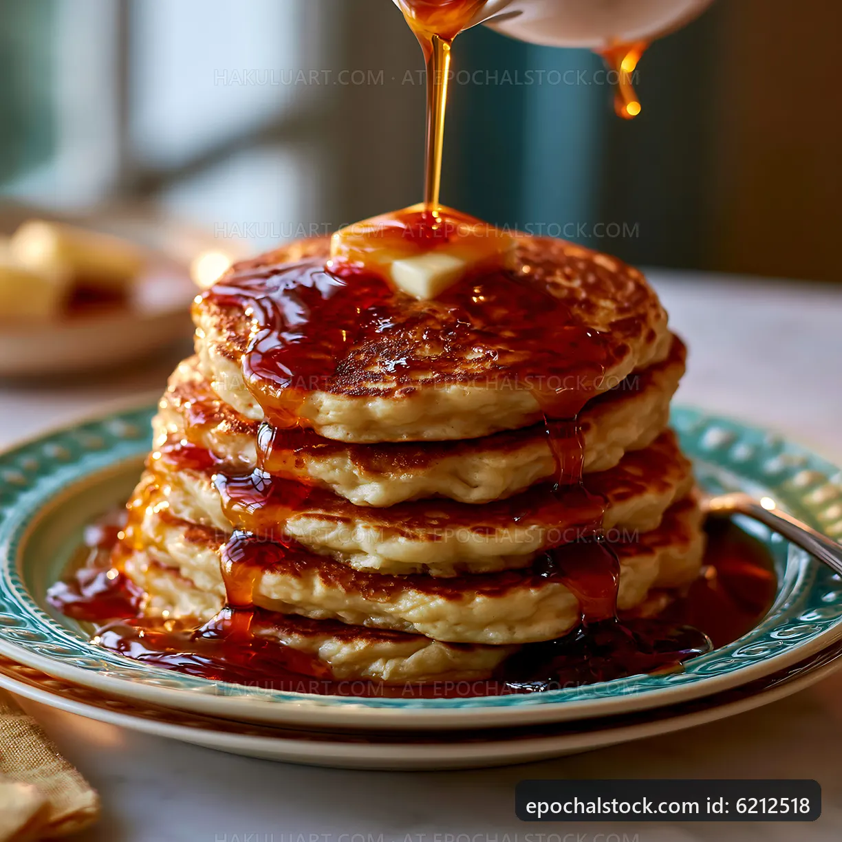 Pancakes served with syrup and butter on a plate