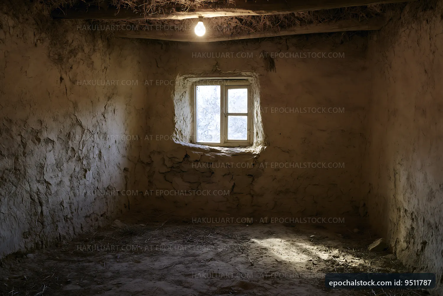 Light bulb hangs in an empty room with a small window