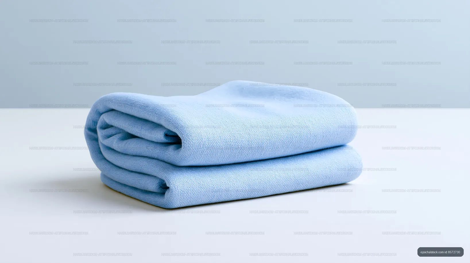 Soft blue towel neatly folded on a clean surface