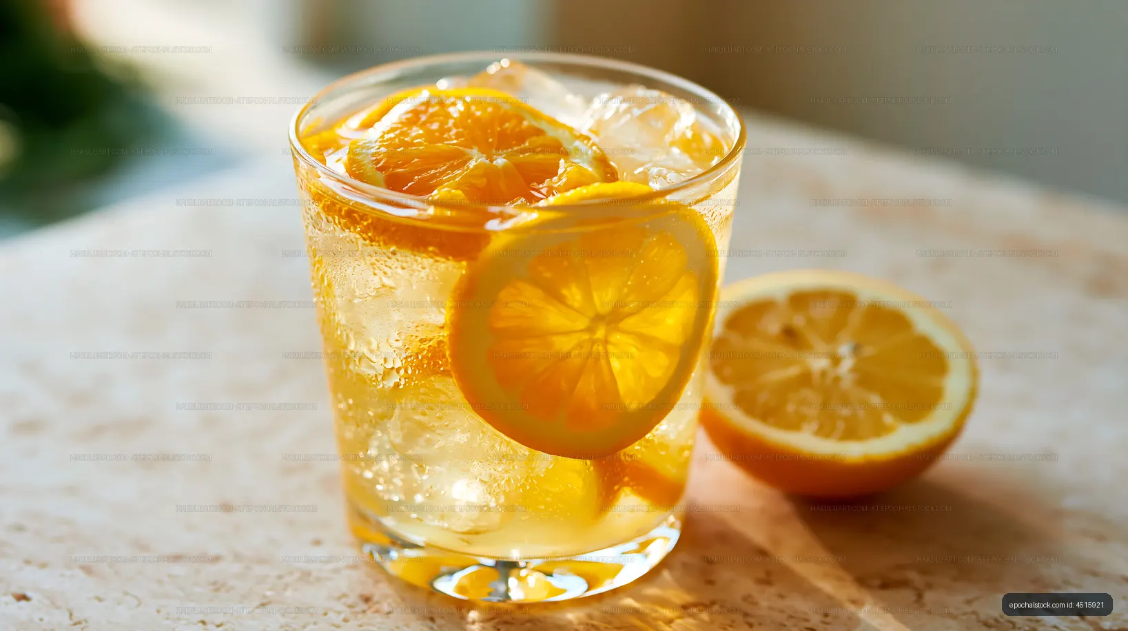 Fresh lemonade in a glass with lemon slices on a table