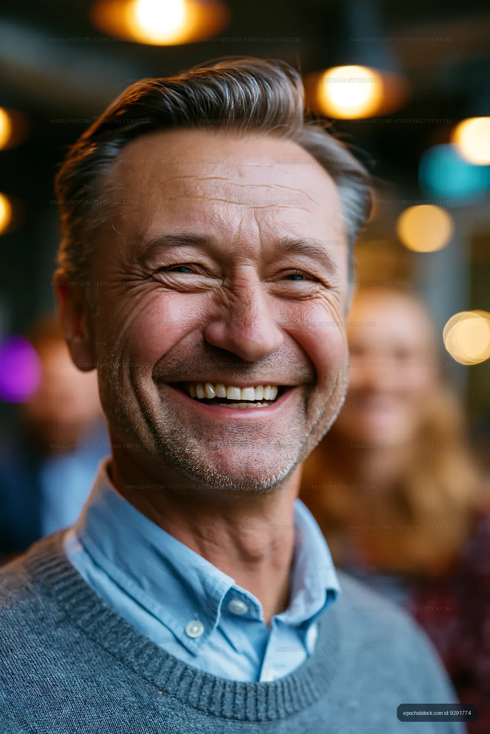 Smiling man with gray hair at a social gathering