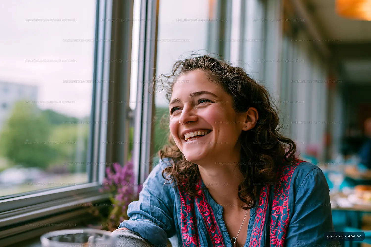 Cheerful woman sitting by window in a casual setting