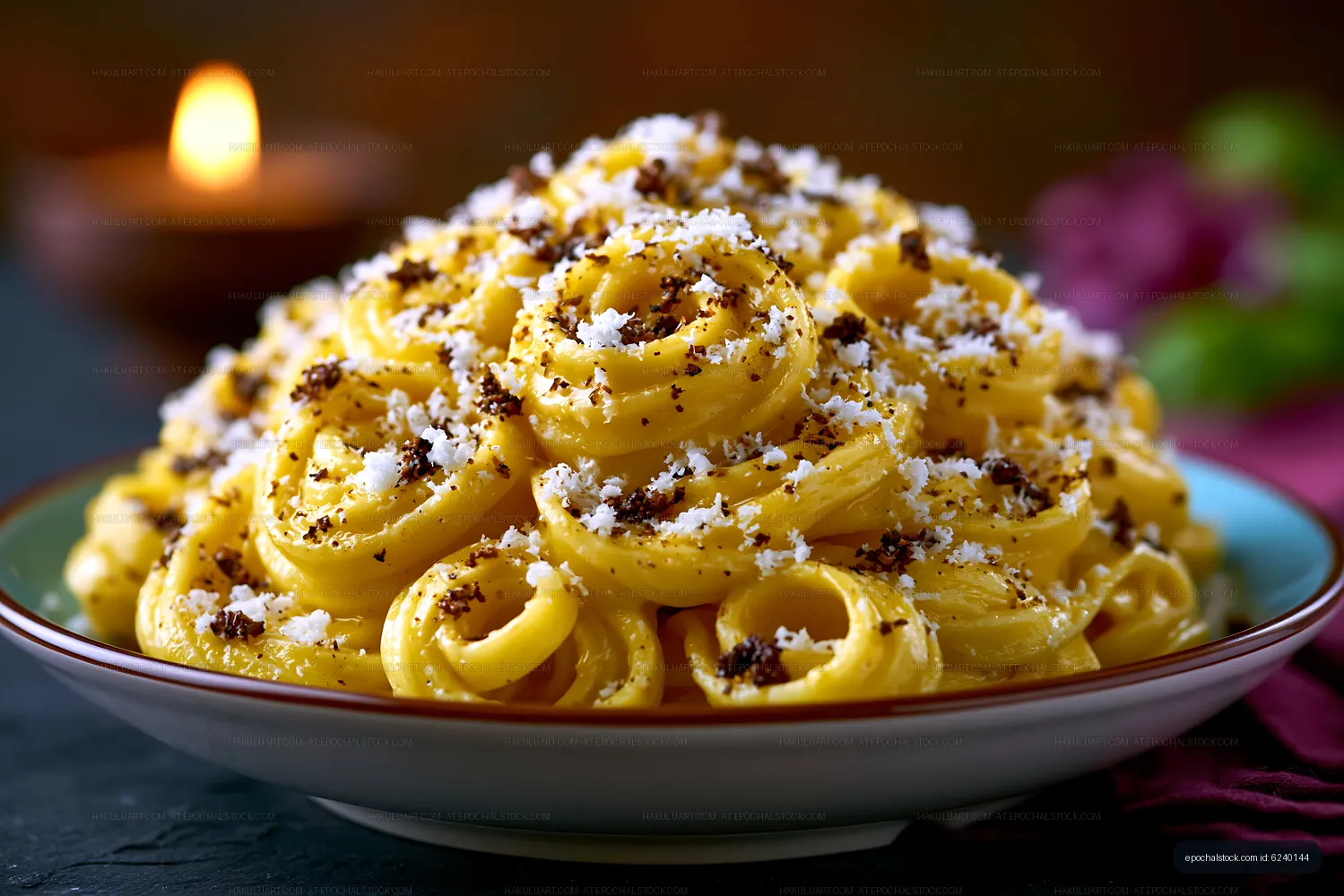 Creamy pasta dish with cheese and black pepper on a plate