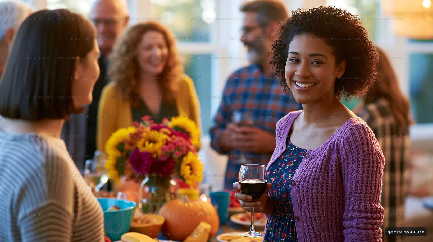 Group of friends enjoying a gathering with food and drinks indoors