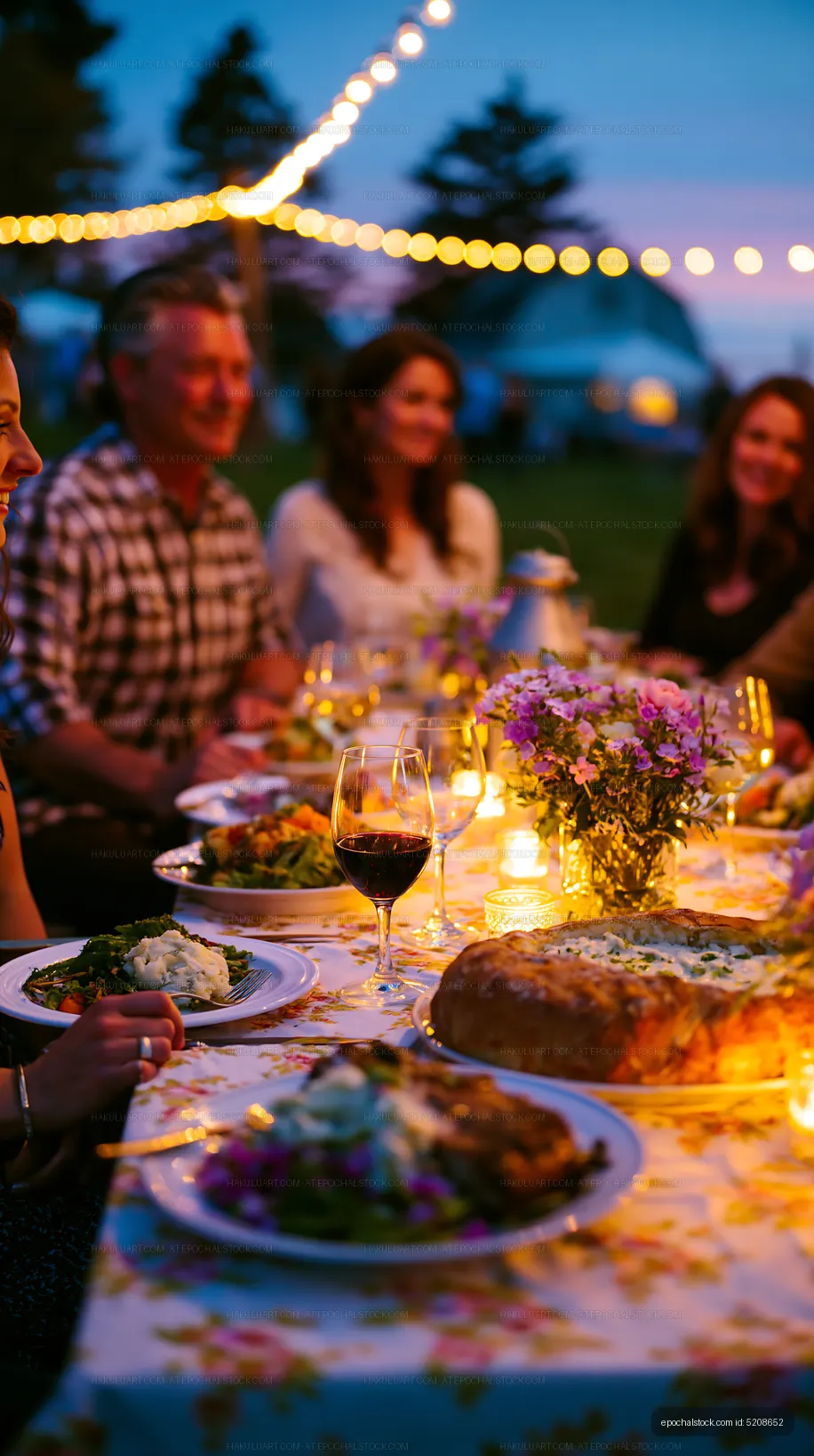 Outdoor dinner party with friends at sunset