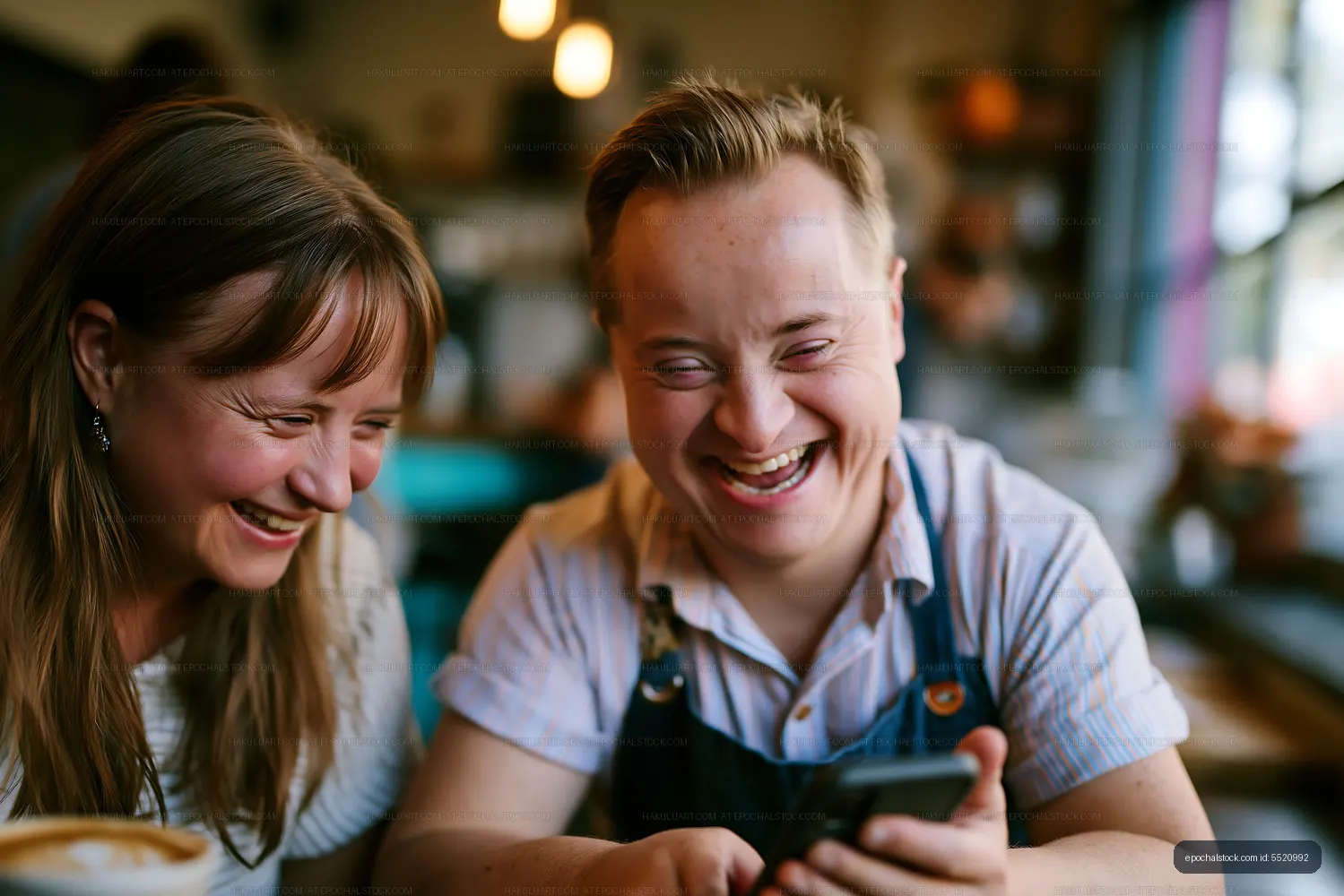 Friends share a joyful moment while looking at a phone
