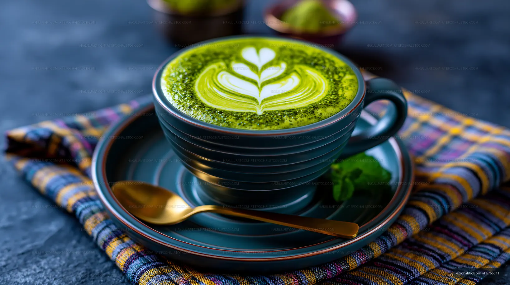 Matcha latte in a blue cup on a plaid napkin