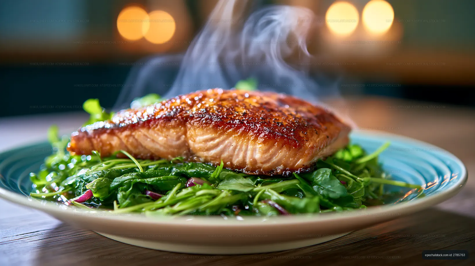 Steaming salmon fillet served on a bed of fresh greens