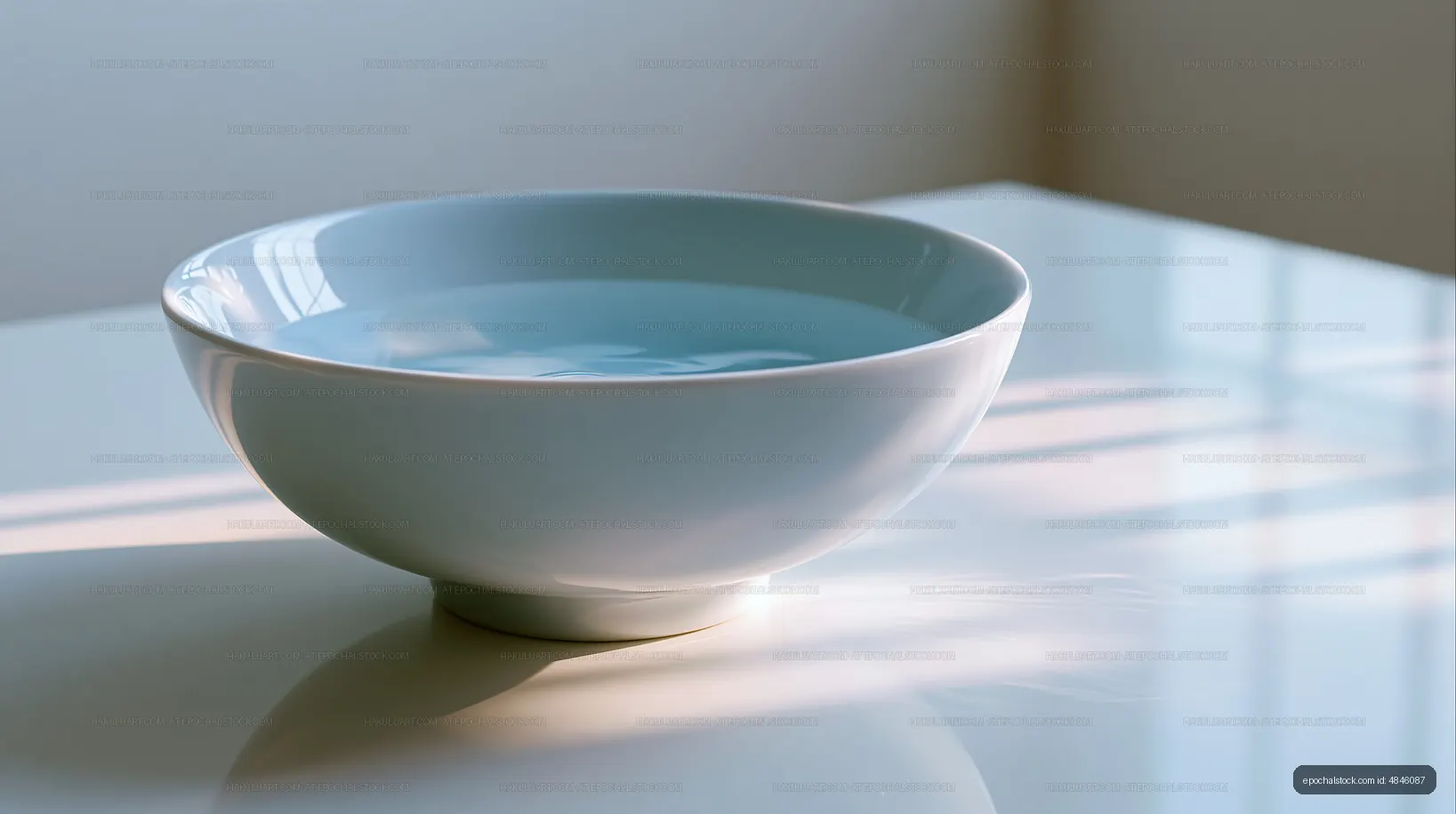 Simple bowl filled with water on a white table