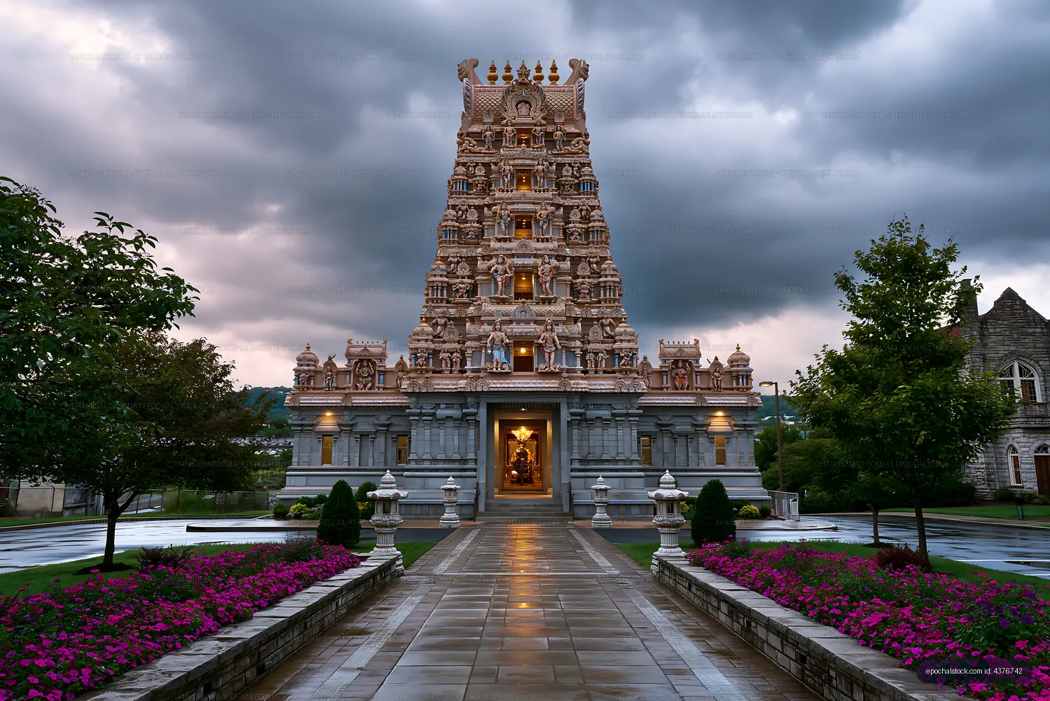 Hindu temple with stone tower under cloudy sky