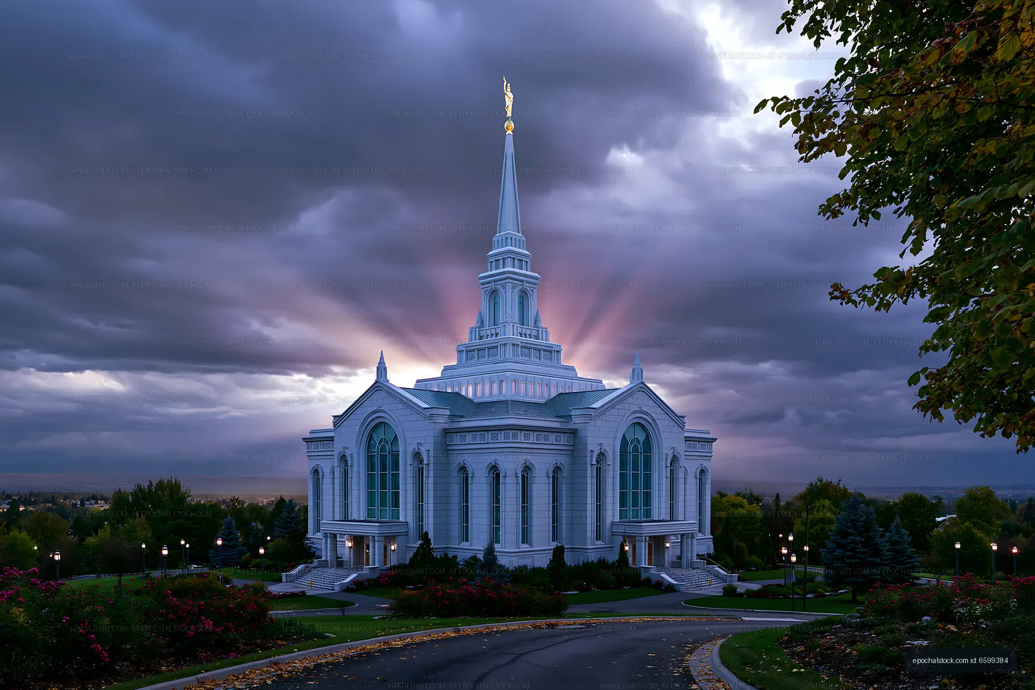 Church building with tall spire and cloudy sky during sunset