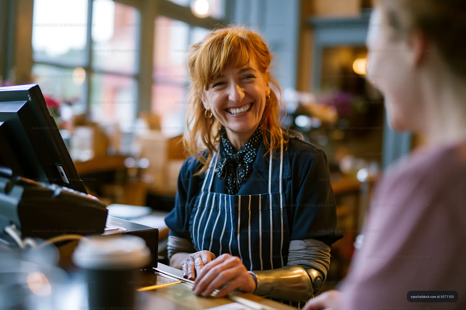 Friendly cashier at a busy cafe serving a customer