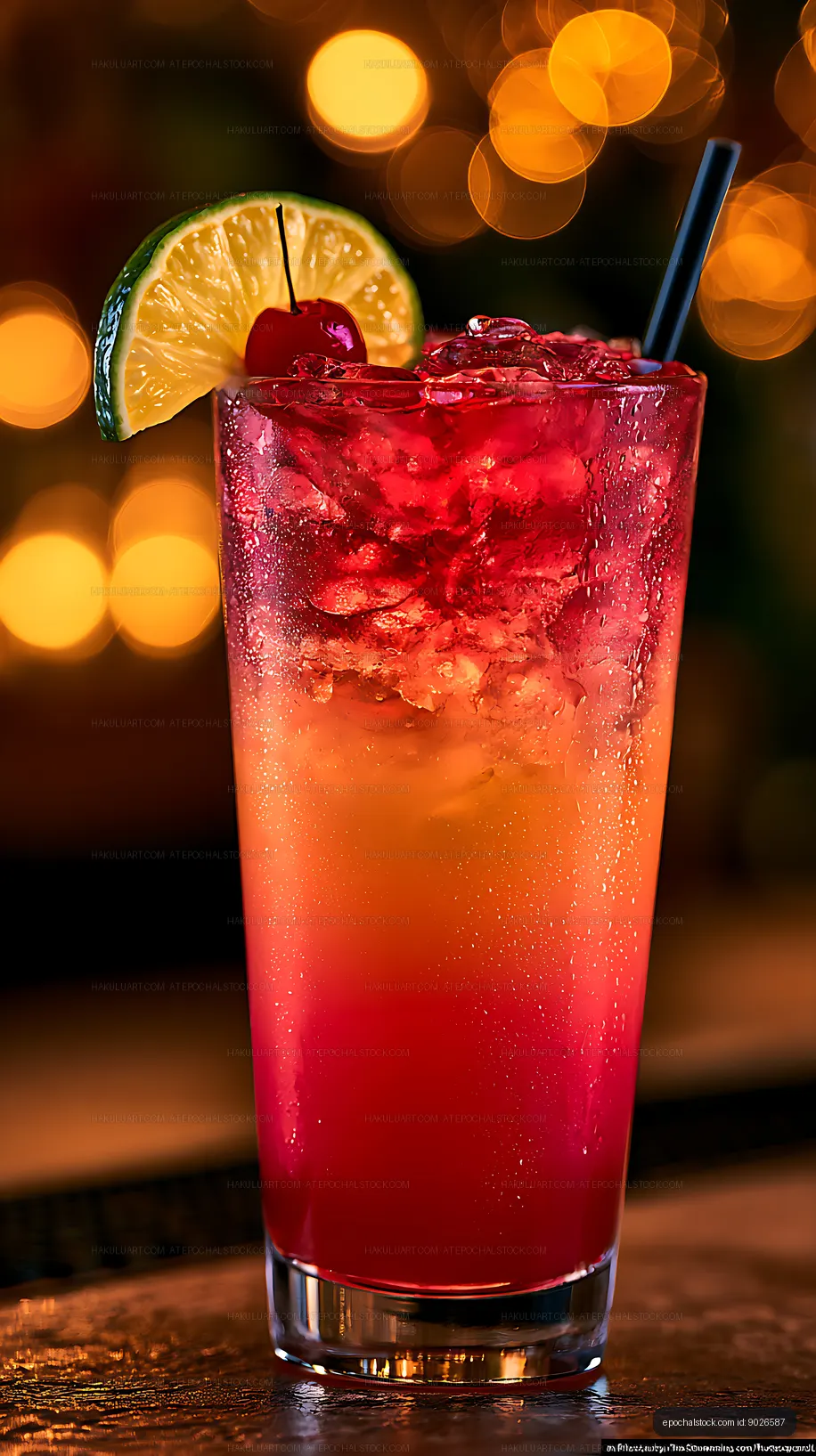 Colorful cocktail with cherry and lime on a bar counter