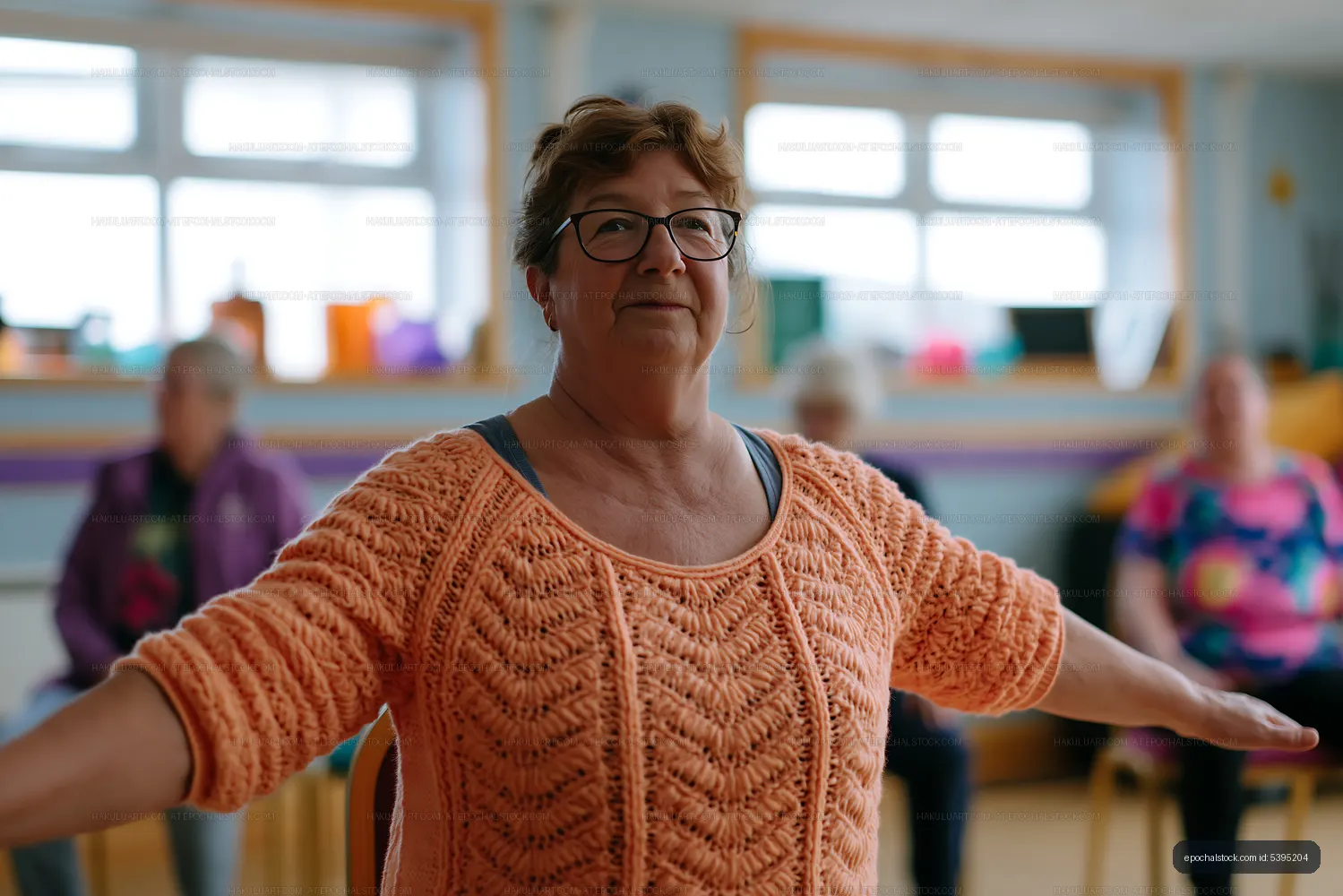Senior woman participating in exercise class indoors