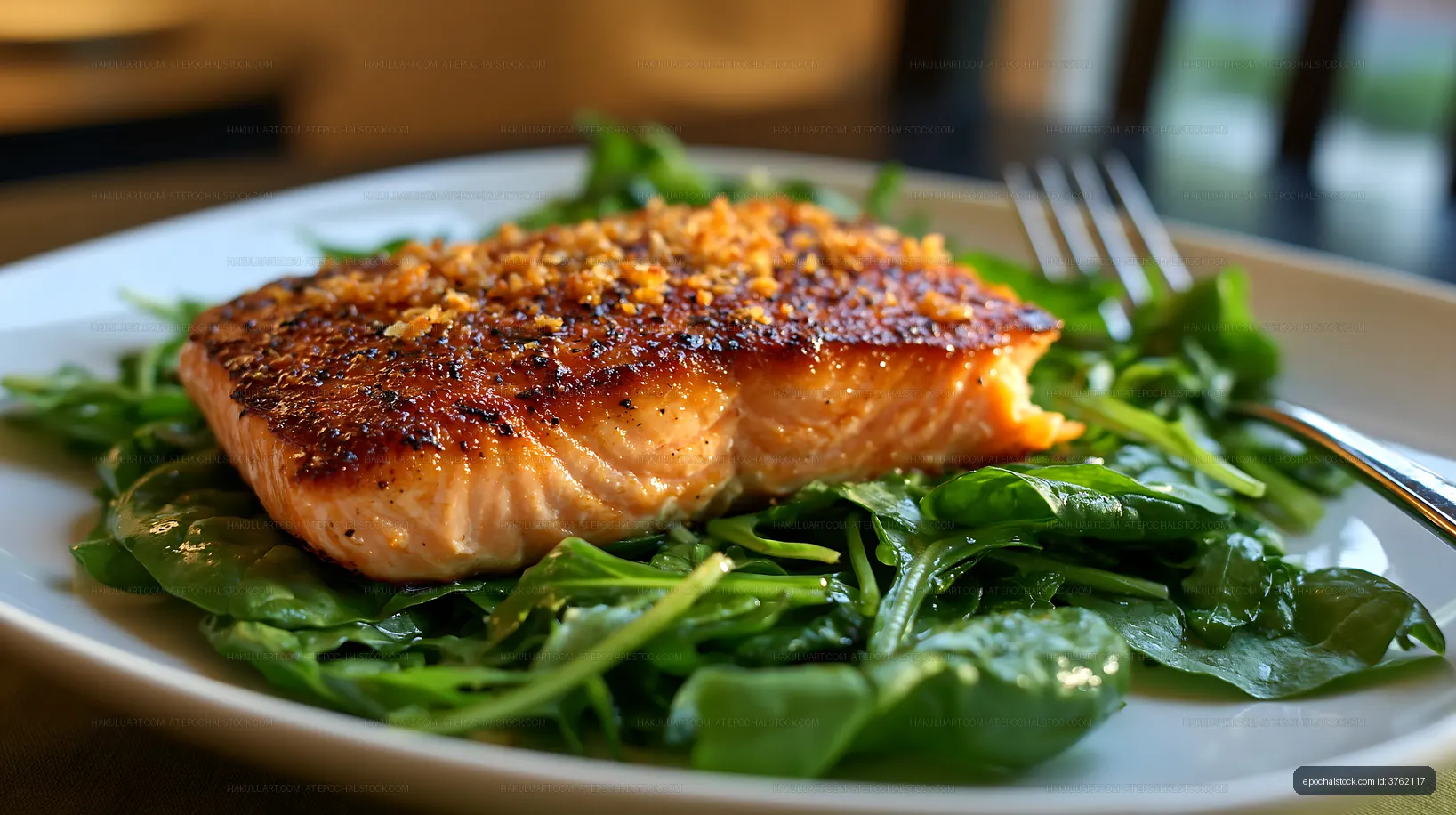 Grilled salmon fillet served on a bed of fresh spinach