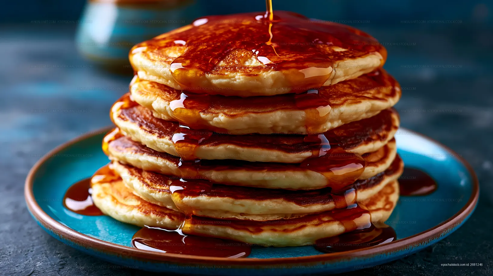 Stack of pancakes with syrup drizzling down