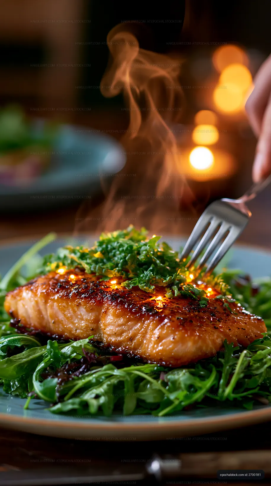 Grilled salmon on a bed of arugula with herbs and steam