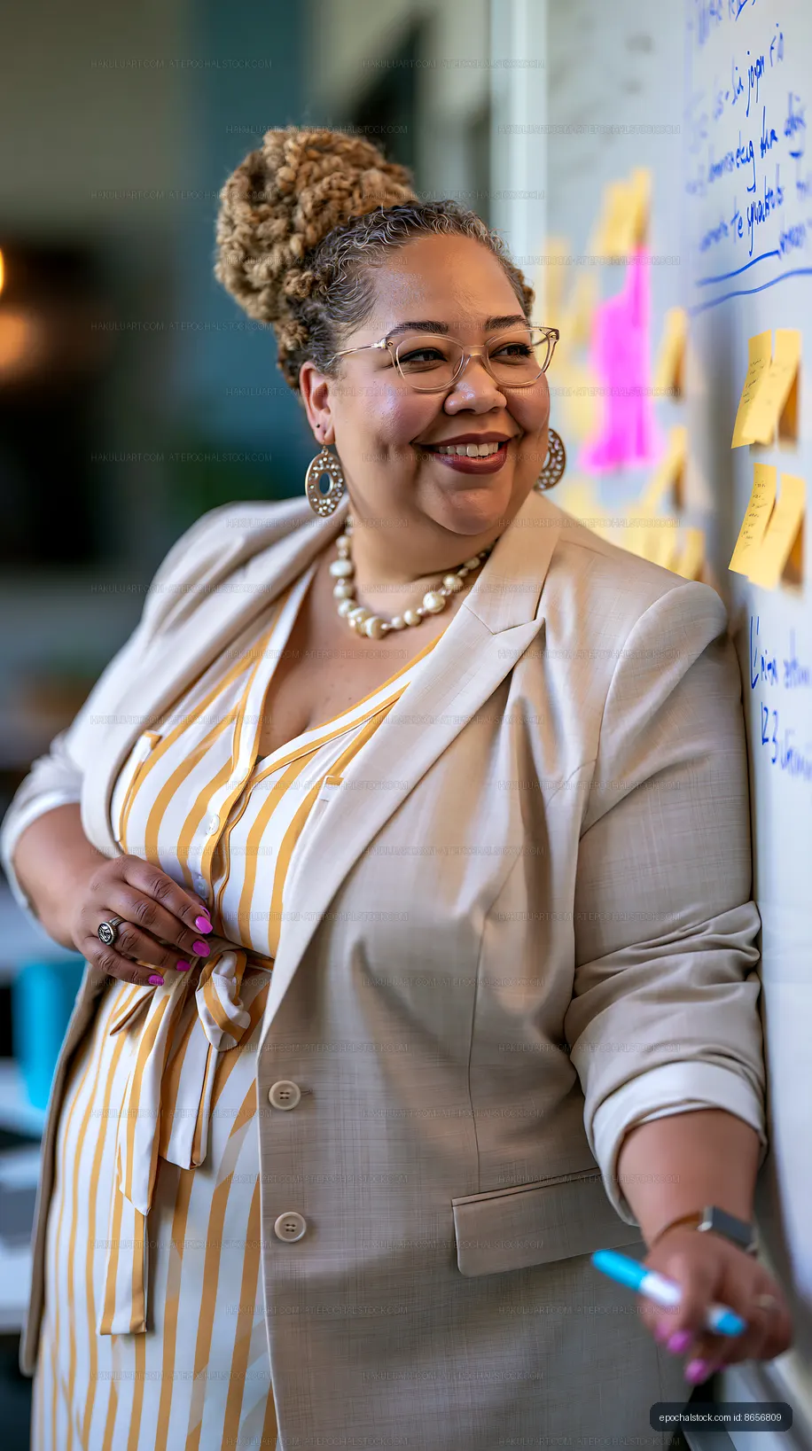 Woman smiling while writing on a wall covered with sticky notes