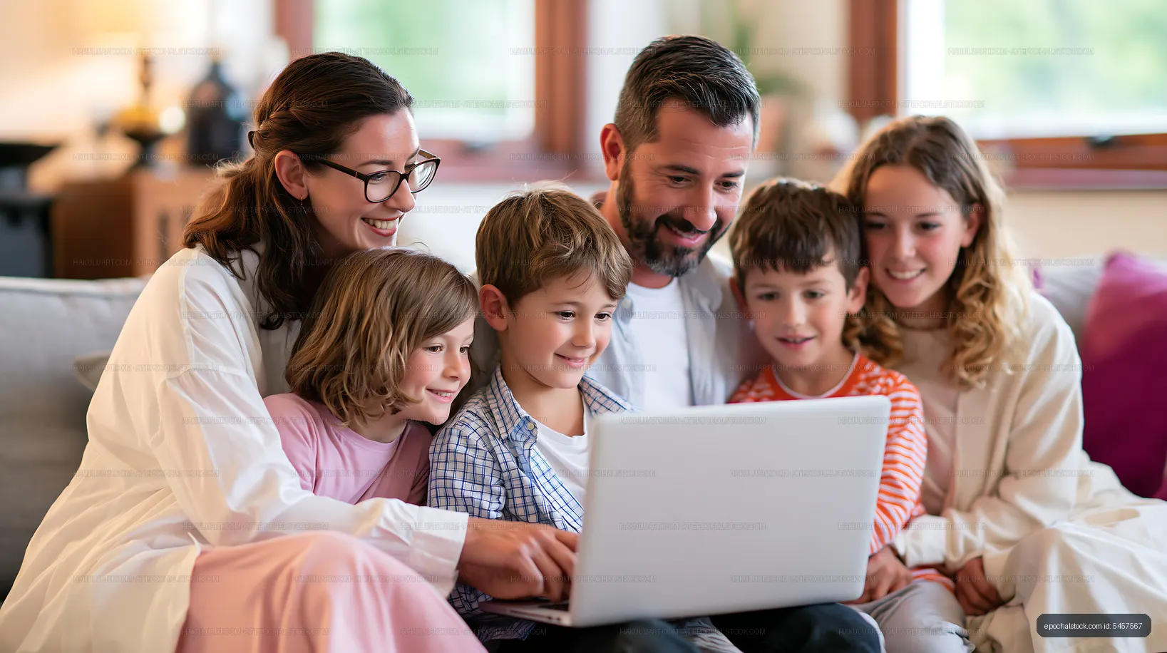 Family enjoying time together while using a laptop at home