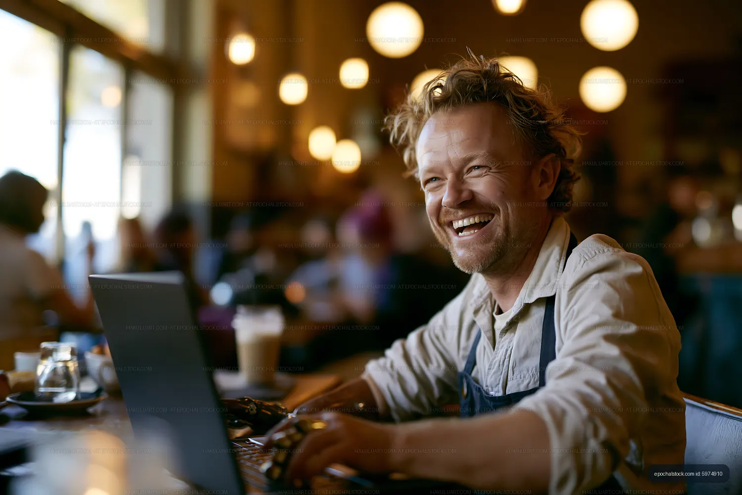 Man working on laptop in cafe with bright lights