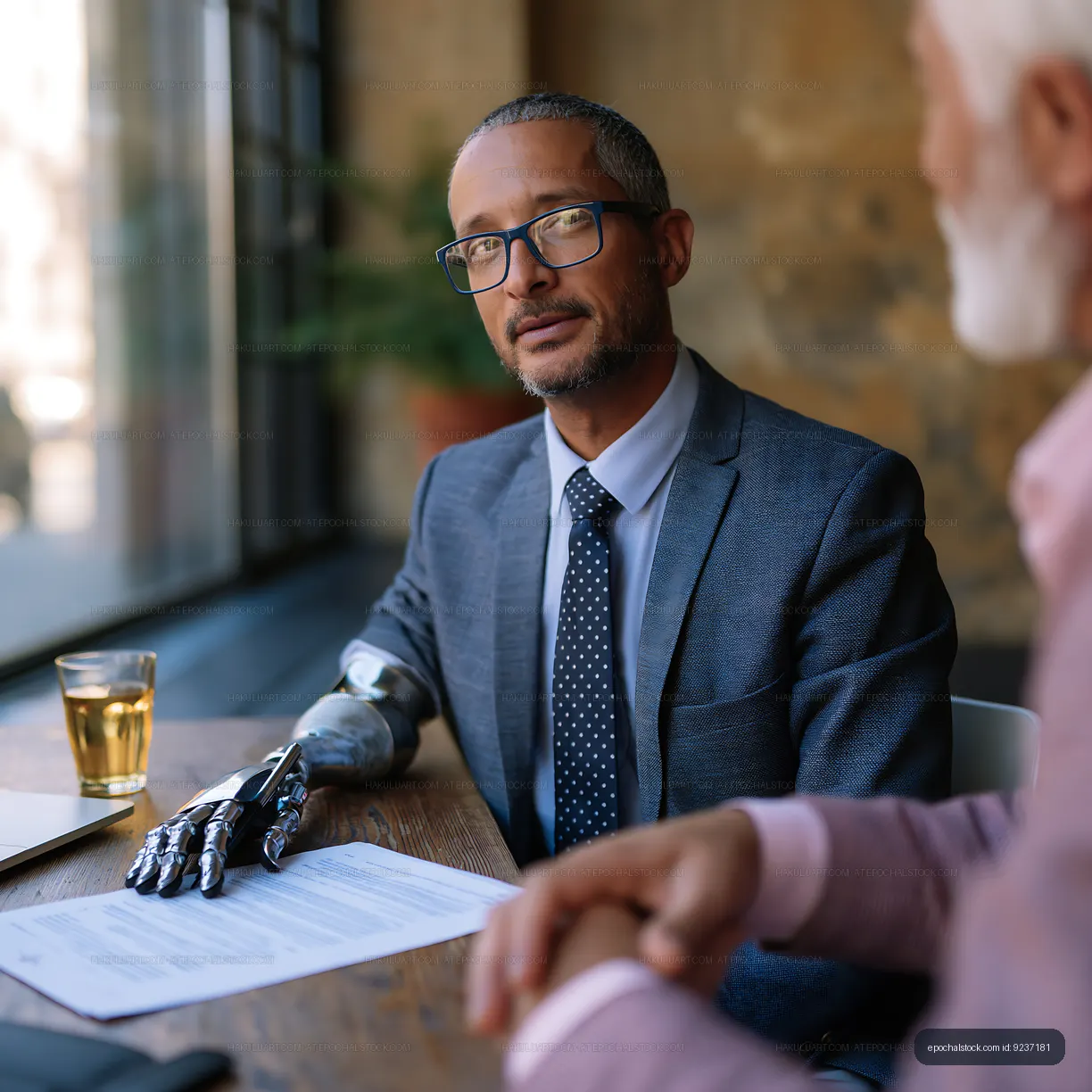 Business meeting with a man with a prosthetic arm in a cafe