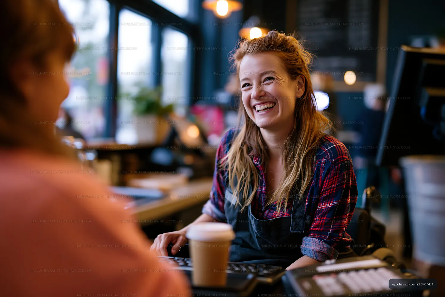 Barista talks with customer in cafe during the day