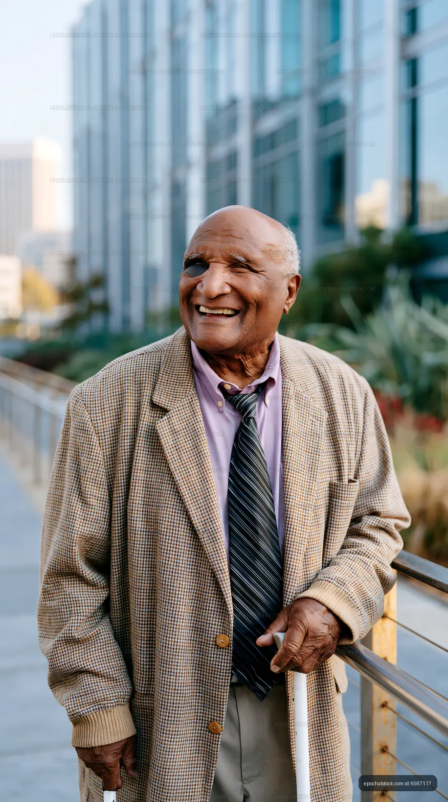 Senior man smiling outdoors in urban area with buildings around
