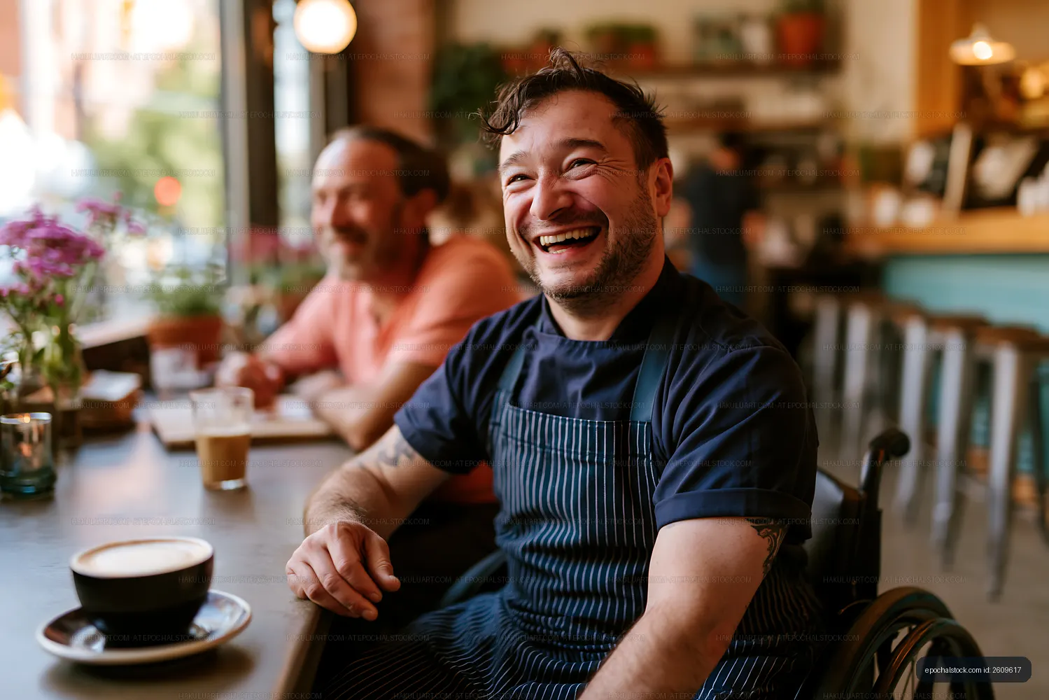 Chef in wheelchair enjoying coffee in a cafe with friends