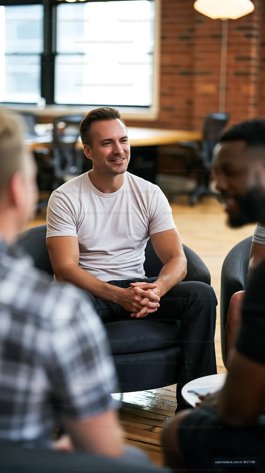 Smiling man in a relaxed indoor group discussion