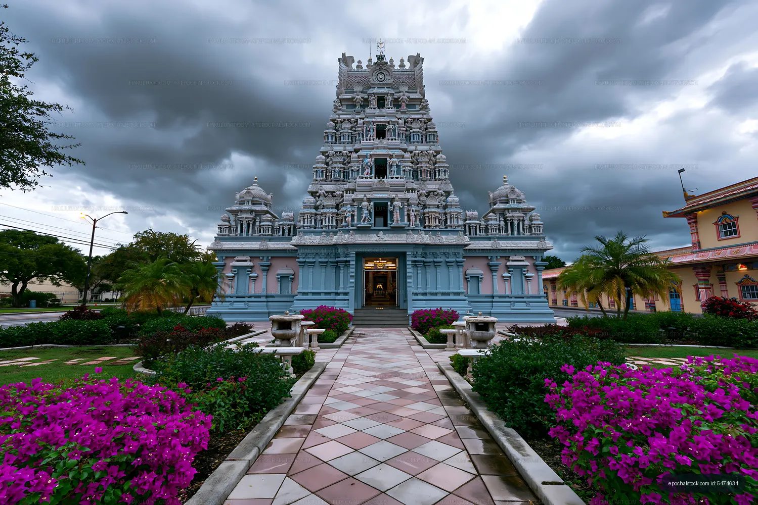Hindu temple facade surrounded by tropical flowers