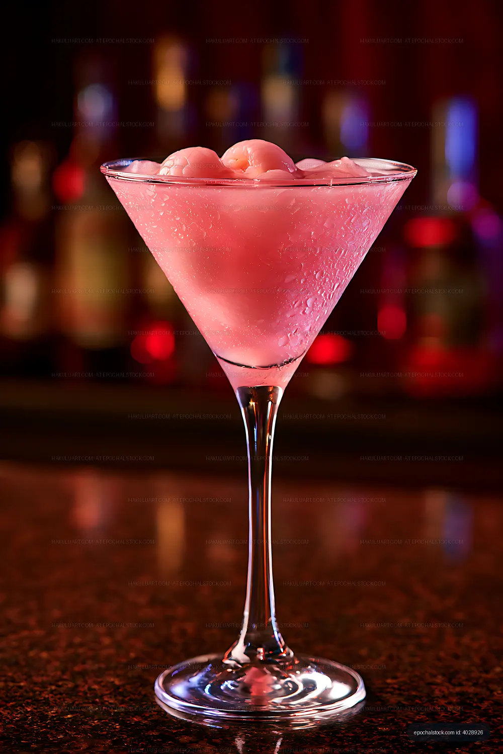 Pink cocktail served in a condensation-covered martini glass
