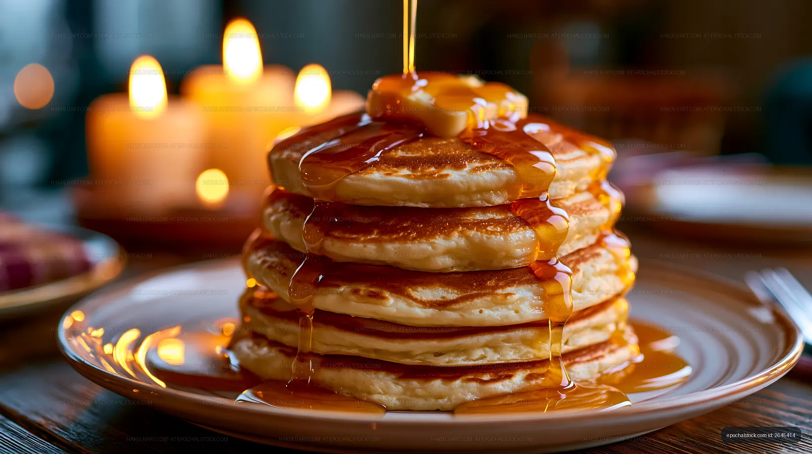 Golden pancakes topped with butter and maple syrup