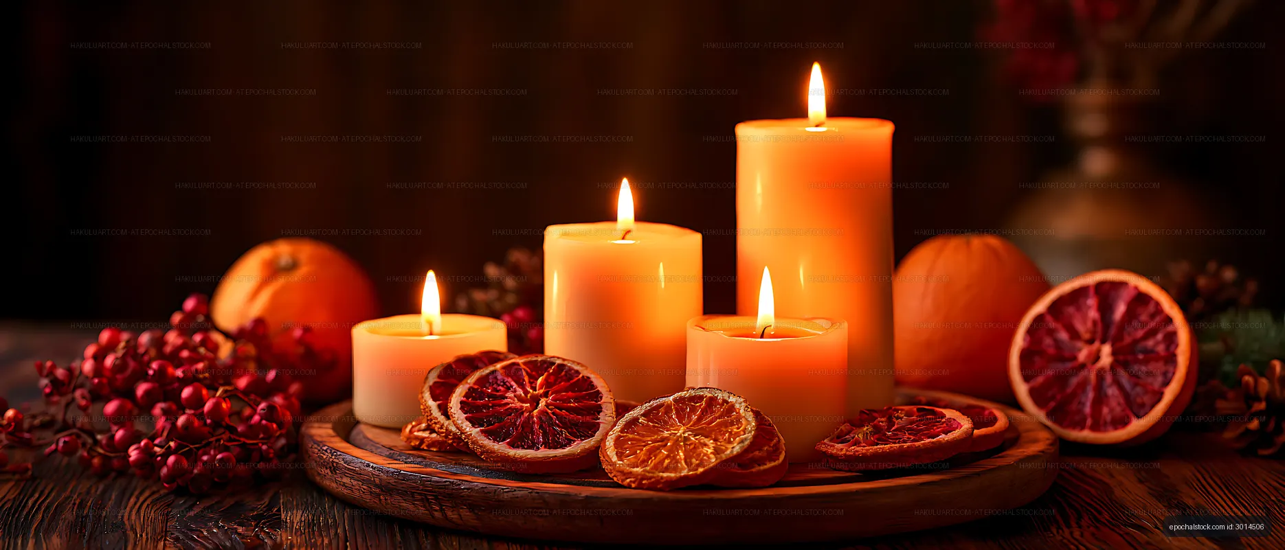 Four glowing candles in a rustic citrus arrangement