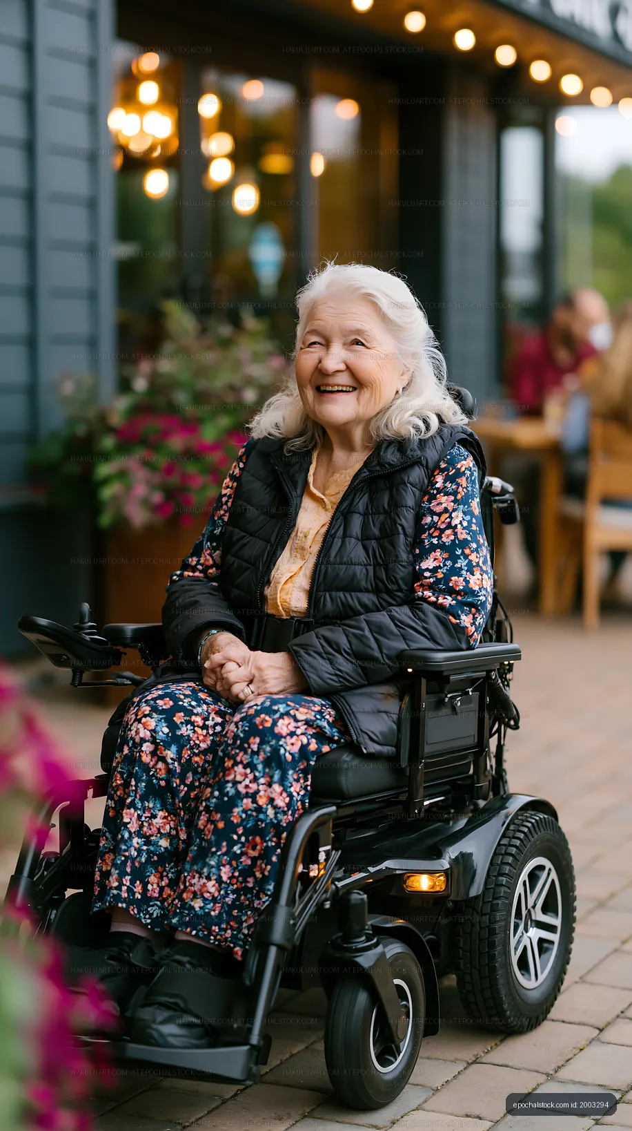 Joyful older woman seated in a wheelchair near a cafe