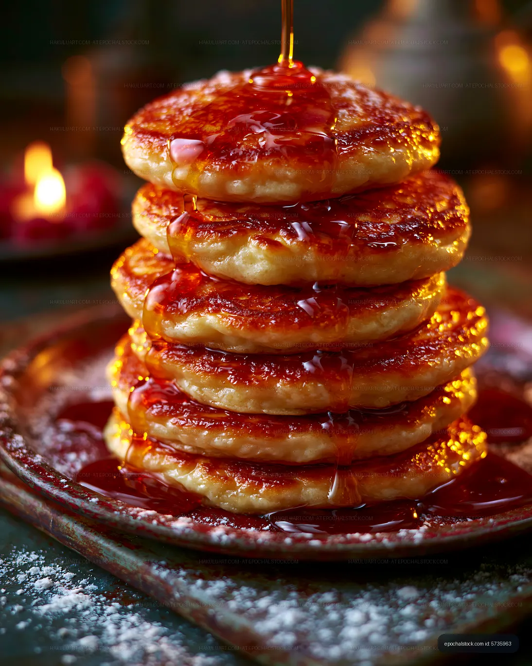 Glossy syrup-drizzled pancakes stacked on a plate