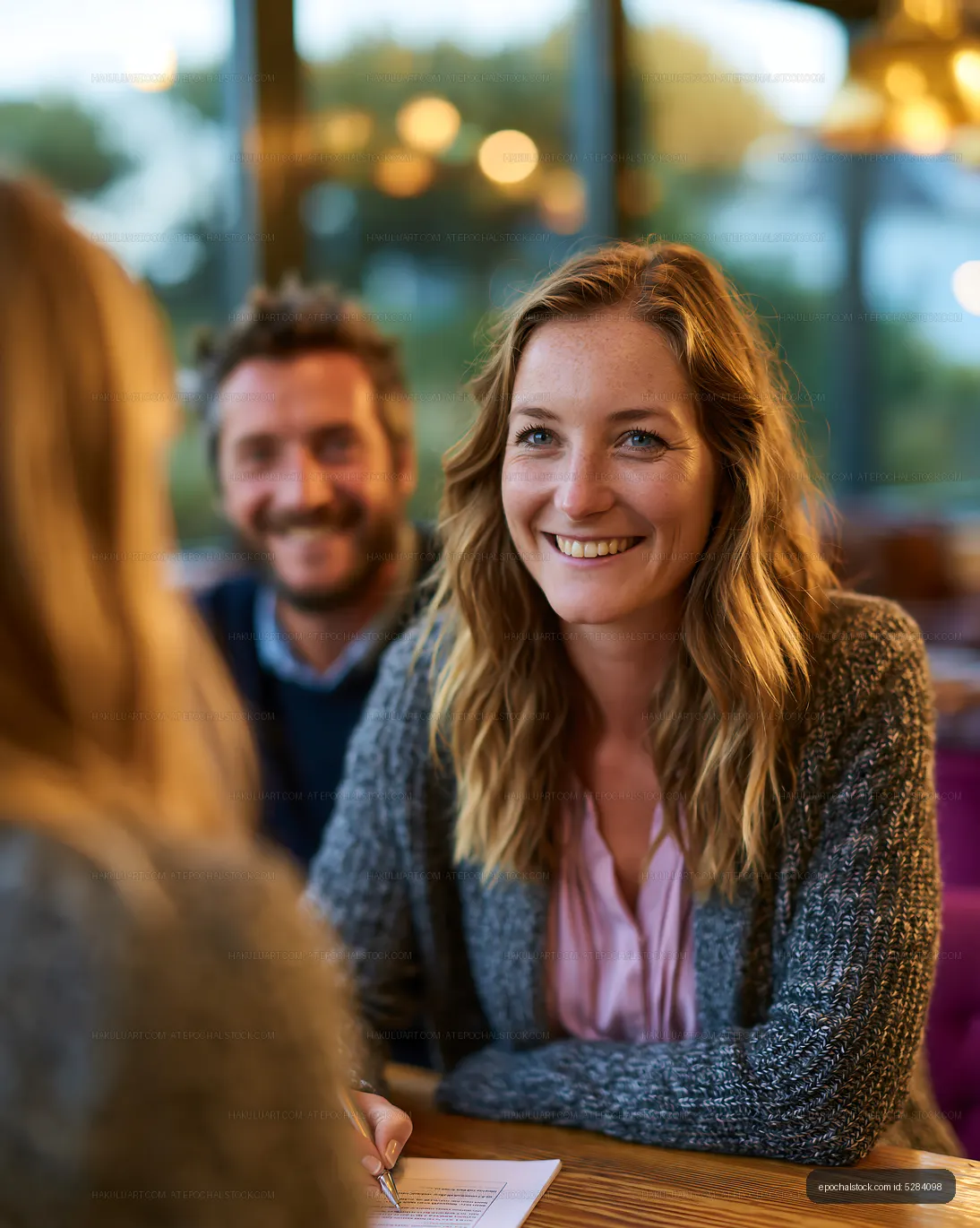 Smiling woman at a warmly lit café table